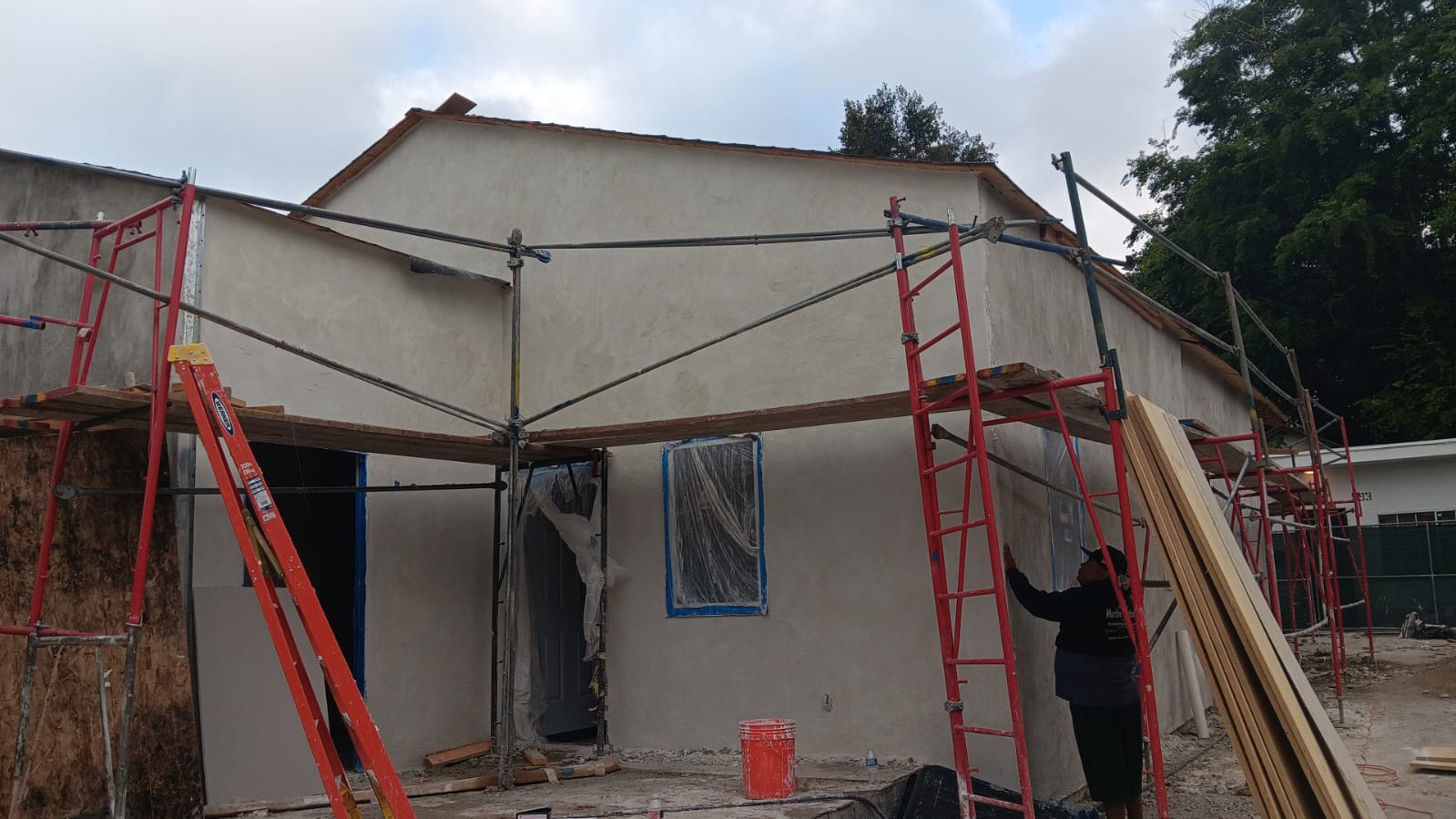 Exterior wall and weather barrier work at a residential construction site