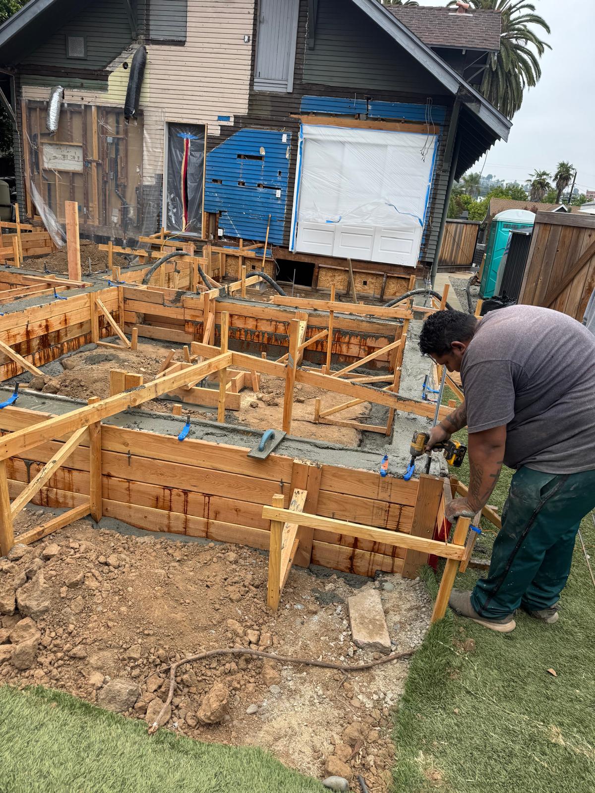 Foundation formwork and utility preparation before construction advances