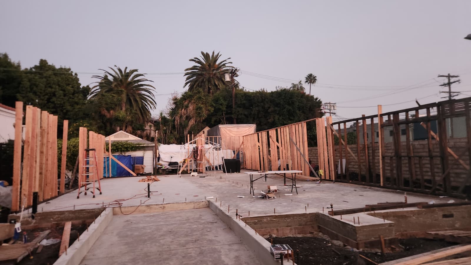 Concrete foundation and framed wall work in progress at a residential construction site