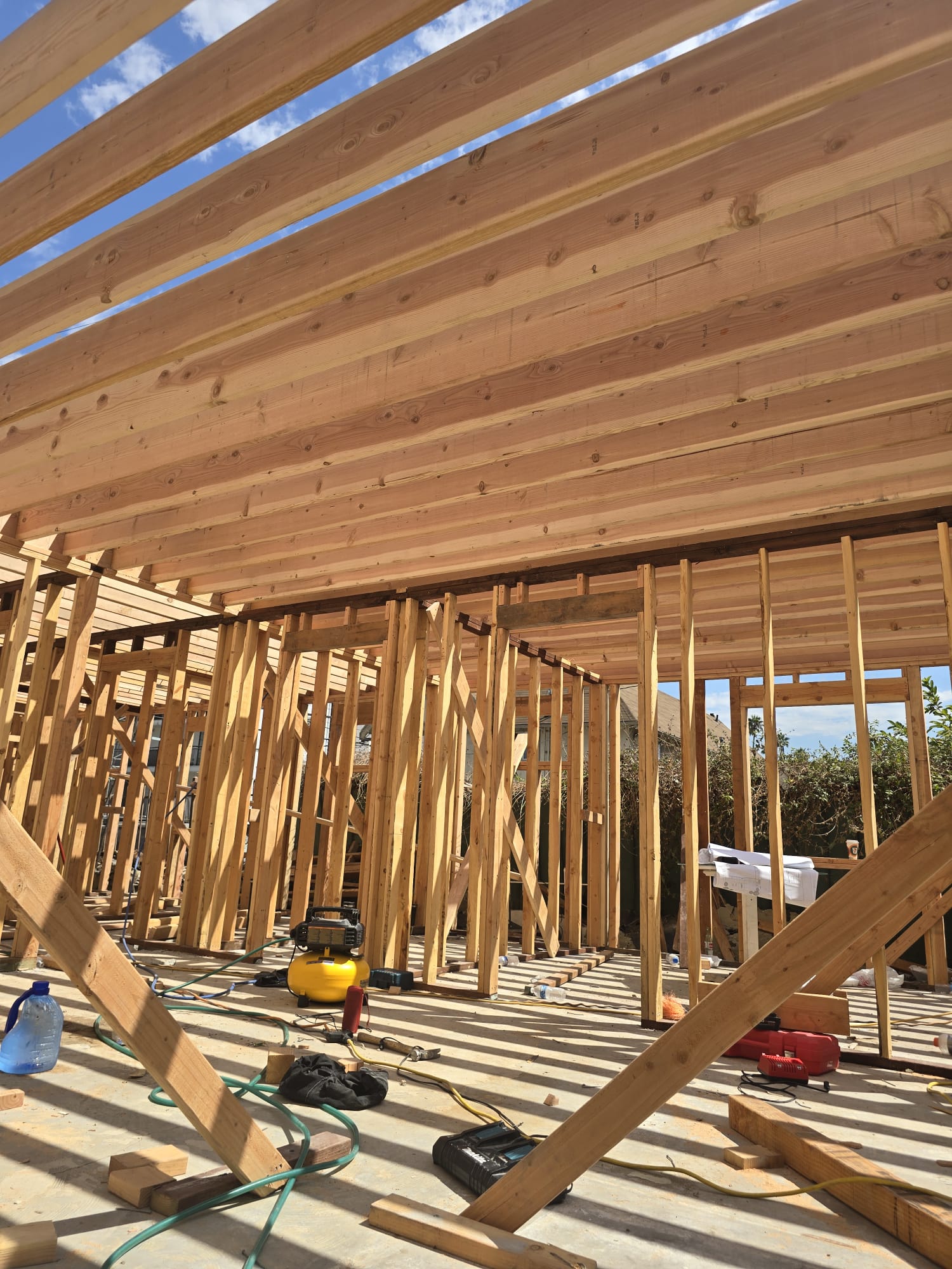 Interior wood framing with wall studs and ceiling joists